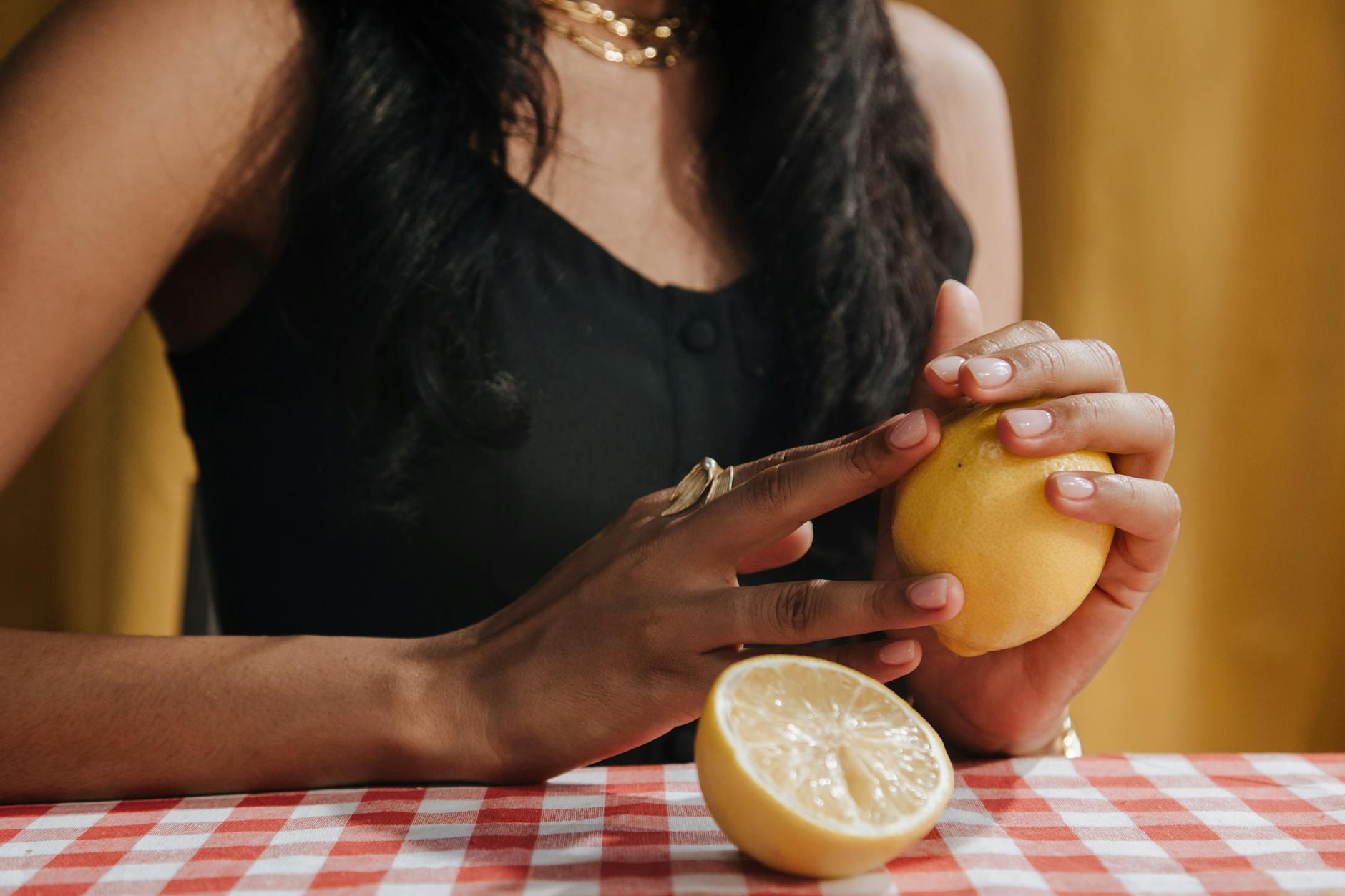 Woman holding colorful vibrators in a thoughtful moment